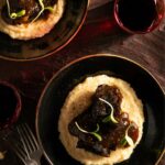 Tender braised beef atop cheesy grits.