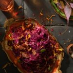 An aerial view of a serving tray spilling over with sweet and sour red cabbage.