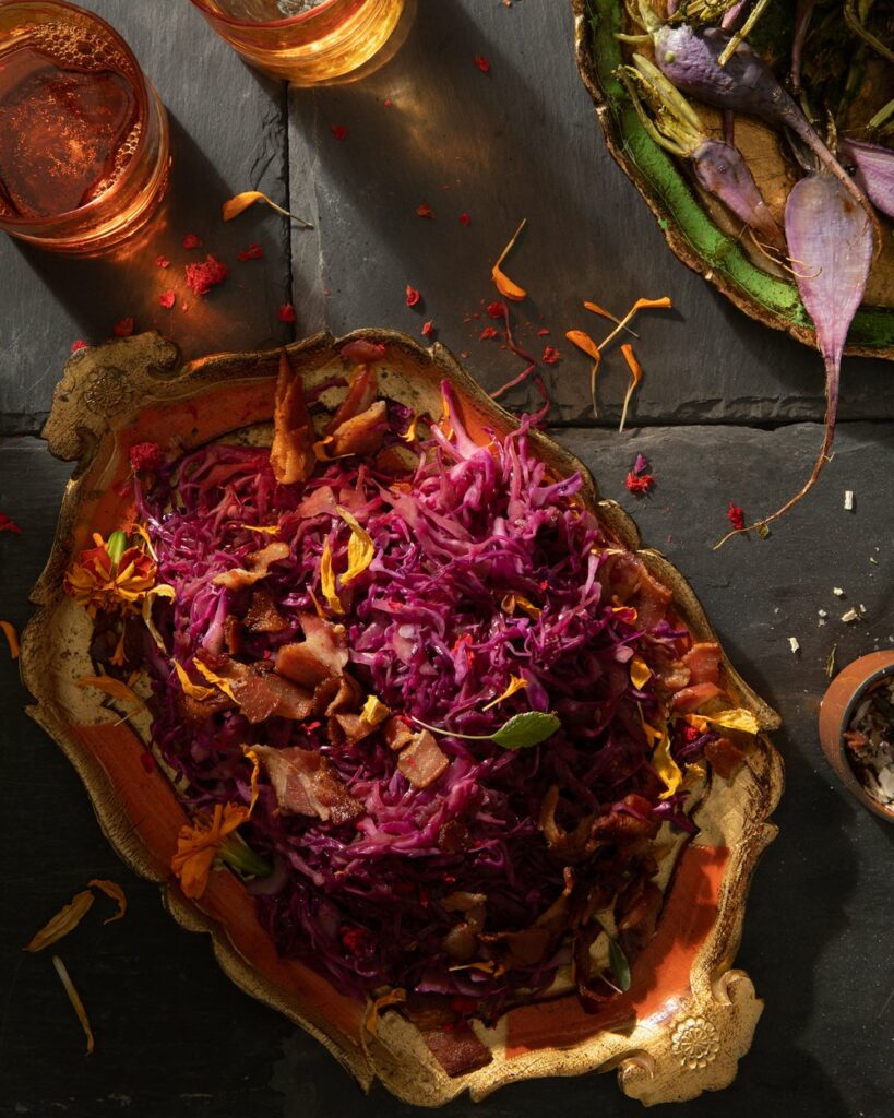 An aerial view of a serving tray spilling over with sweet and sour red cabbage.