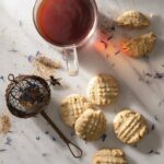 a cup of tea and some cookies on a table.