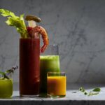 4 glasses of different sizes almost filled with green, red, and orange-colored healthy shots. Best Mocktail Recipes