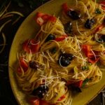 a full plate of Lemon Spaghettini with Olives and Anchovies lying on a table