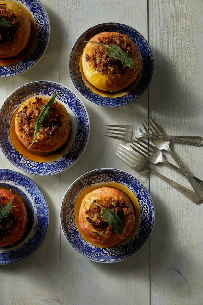 Savory Stuffed Apples served in small plates with four forks on the side