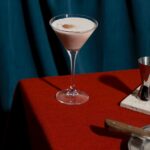 chocolate martini on the edge of a table dressed in a red tablecloth