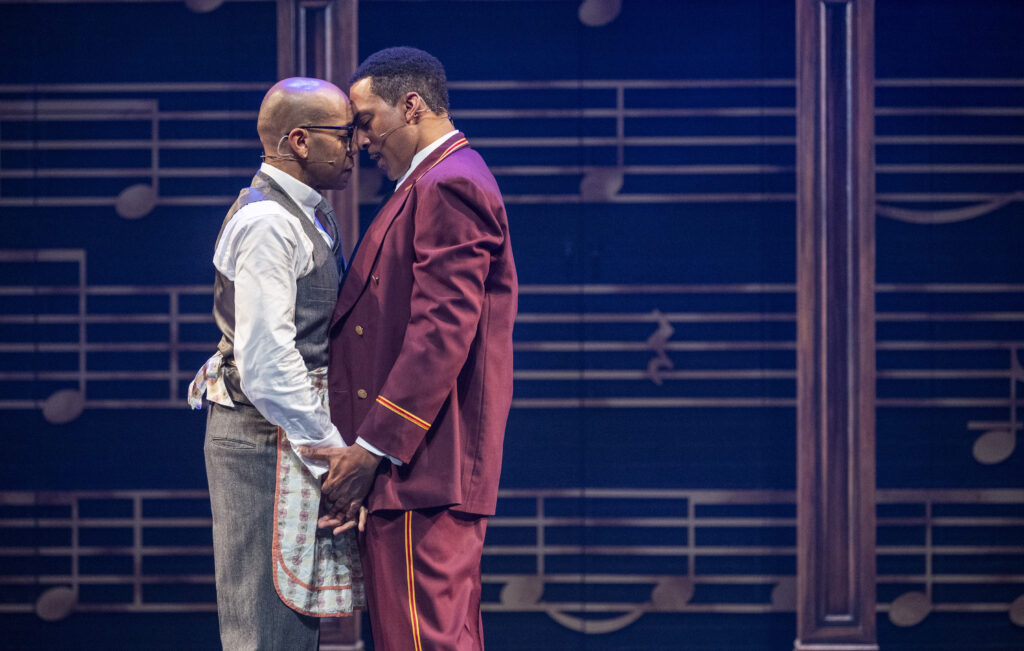 Two black men face towards each other and touch foreheads and hands in Billy Strayhorn: Something to Live For