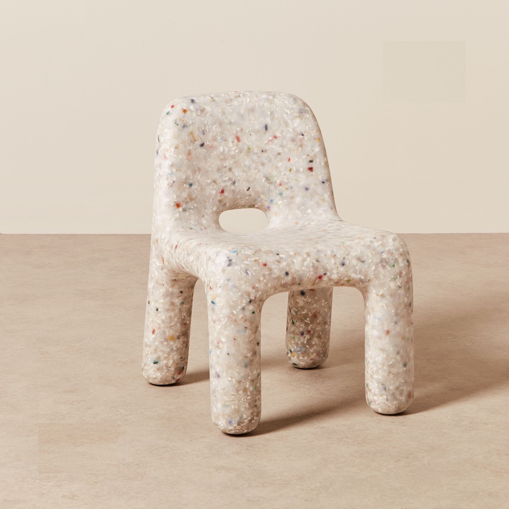a white plastic looking specaled chair, crafted from ecothylene, an exclusive material made from recycled plastic toys. 