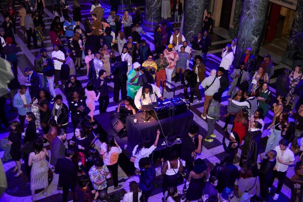 a crowd dances around a dj in the Carnegie Museum of Art