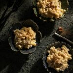 Three mini black bowls filled with pasta coated in Victoria Sande's White Sauce.