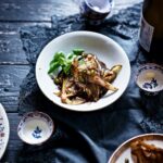 Sautéed Endive with Appelstroop and Five Spices served in a white ceramic plate with small bowls on the side