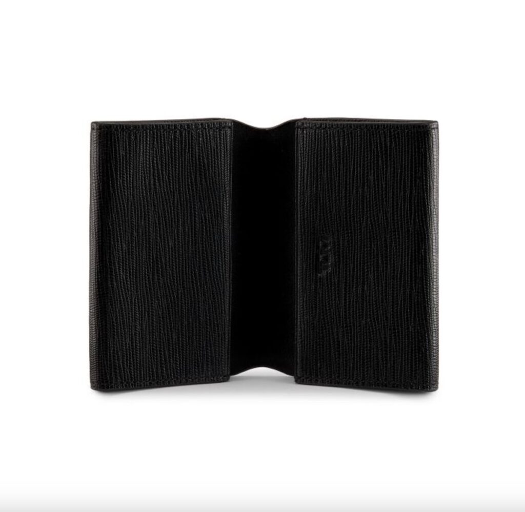 A leather textured bifold wallet in all black sits open on a white background.