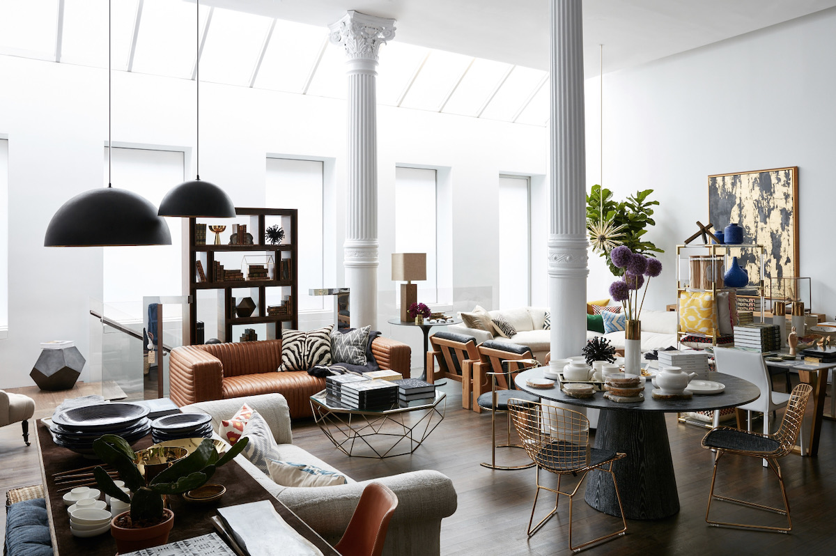 An installation view of Jayson Home in Chicago with couches, chairs, lamps, and columns 