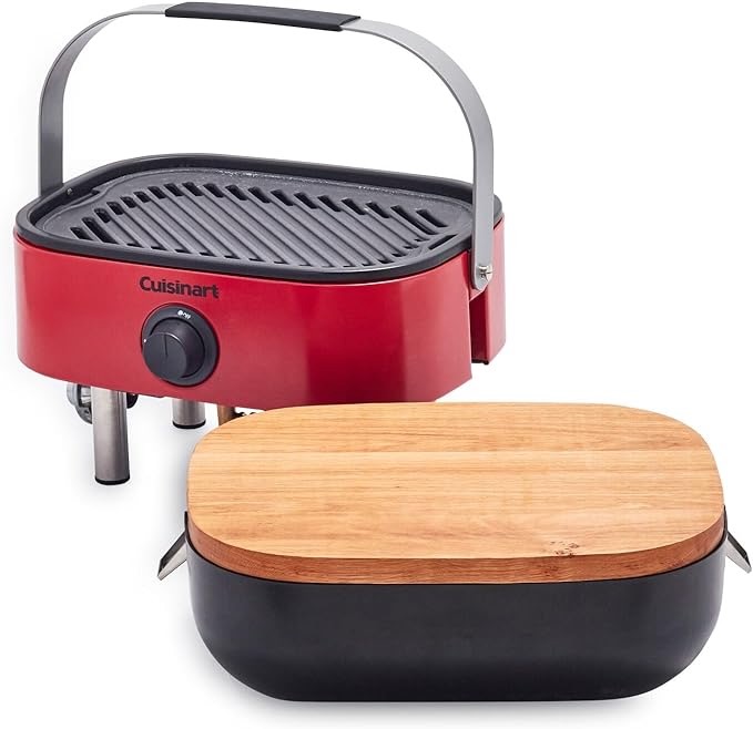 A red travel grill with a silver handle and top wooden case sit on a white background.