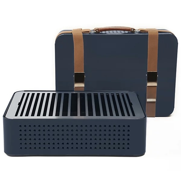A blue travel grill with a blue case featuring brown straps sits on a white background.