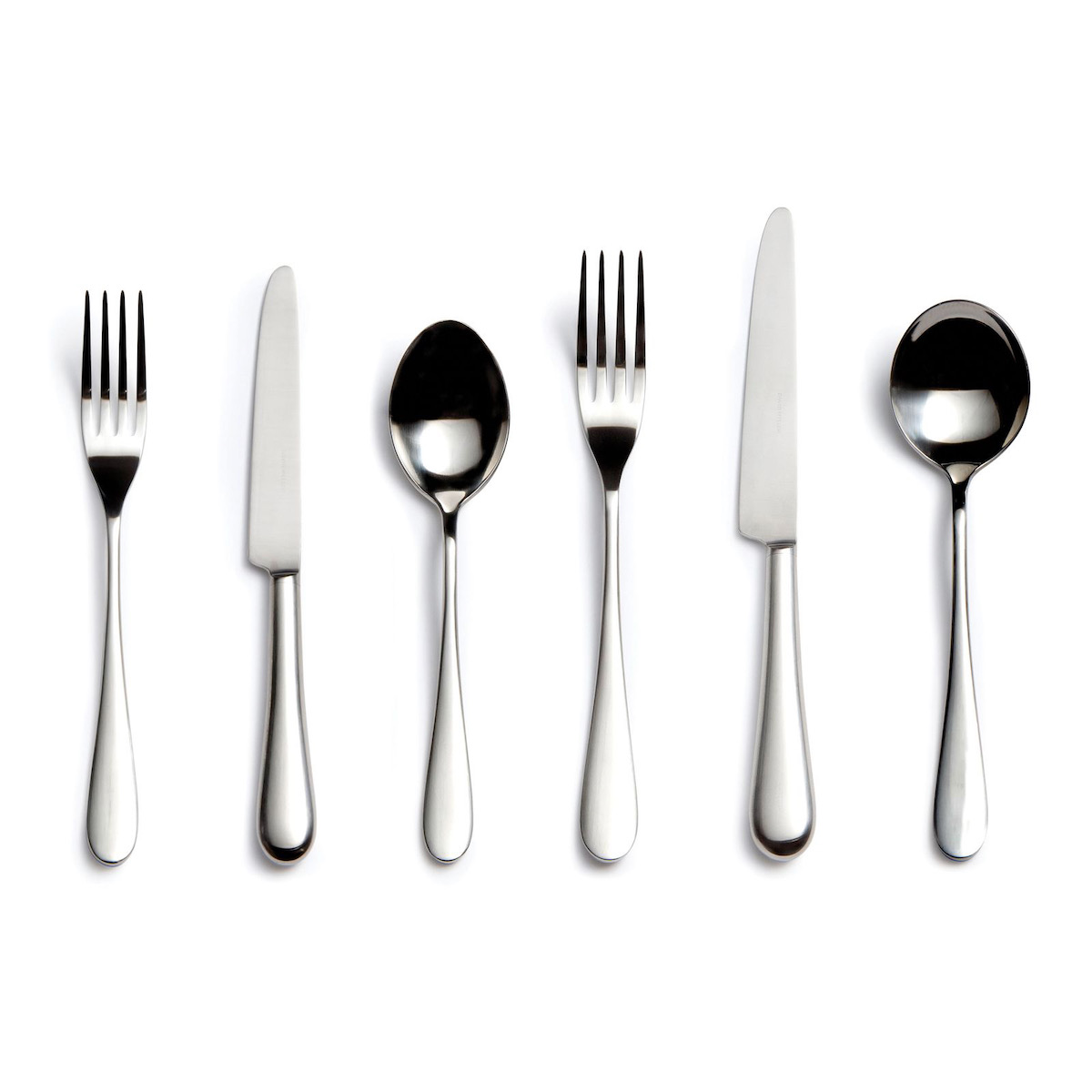 Cutlery arranged alternating fork, knife, spoon, fork, knife, spoon, on a white background 