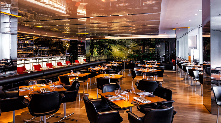 The interior of the bar room at the MOMA, with black marble countertops and large windows 