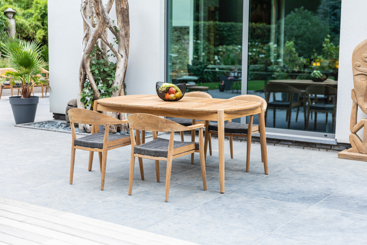 A deck with a chair and tables on a sunny day, from Oasiq furniture