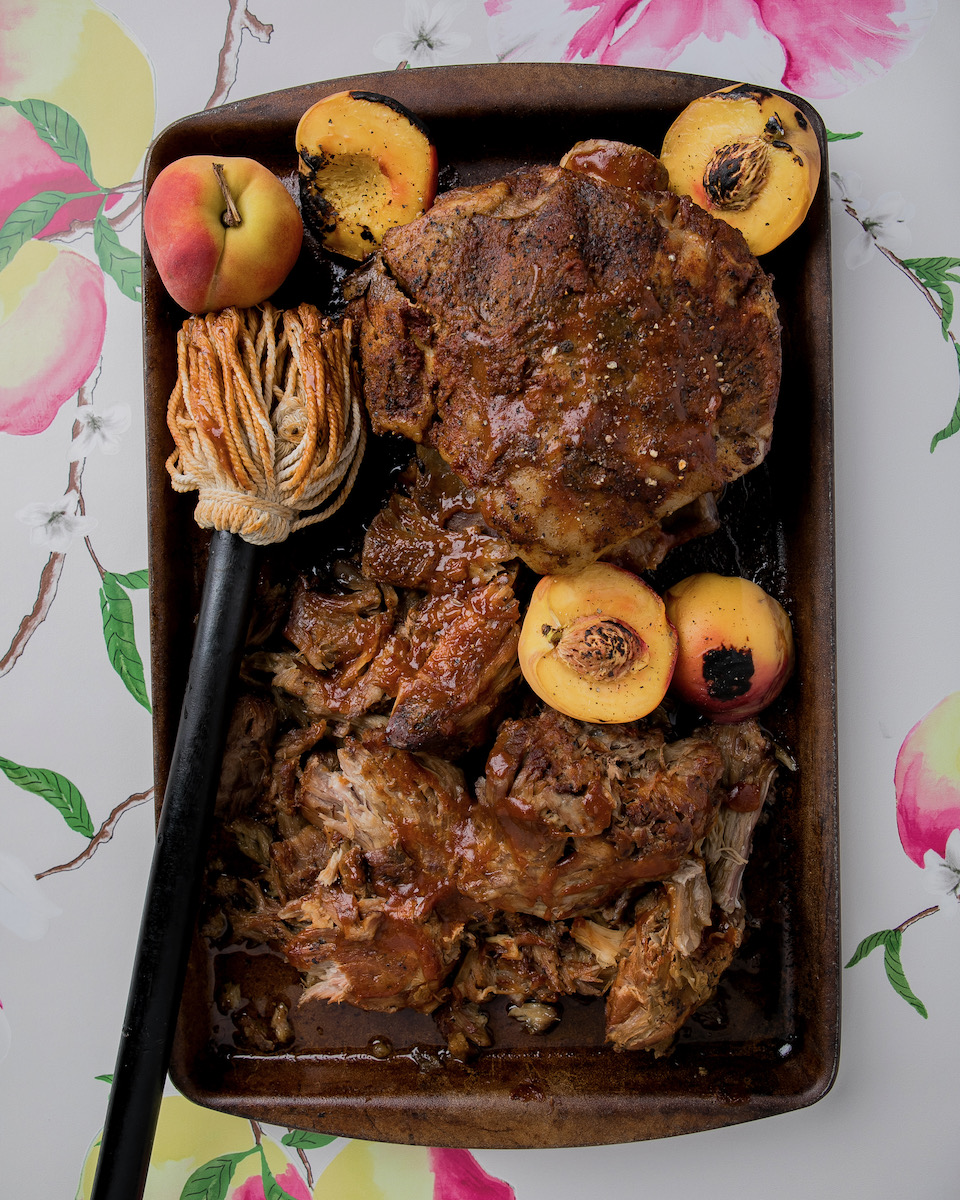 A peach pulled pork summer BBQ recipe styled on a white background