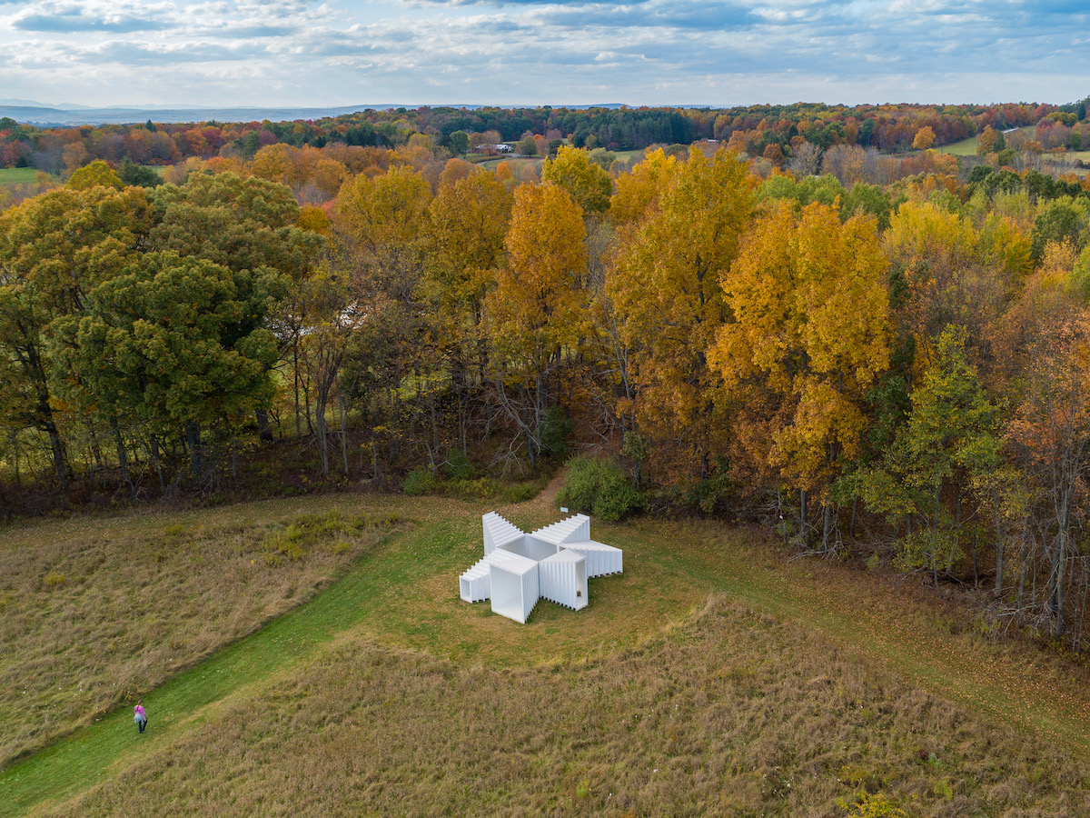 Fall foliage at Art Omi in the Hudson Valley with a white sculpture in the center