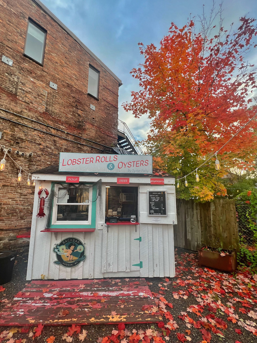 A lush environment of red leaves outside of the restaurant Oyster Party