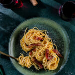 Spaghetti alla carbonara on a green background