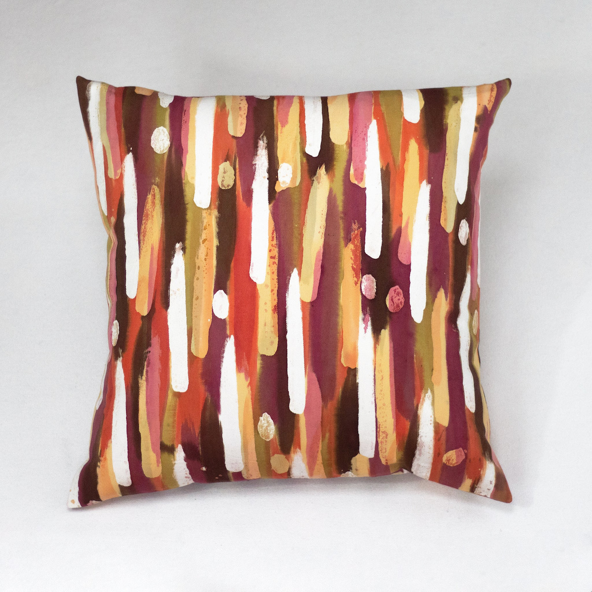 A multi-striped hand painted pillow 