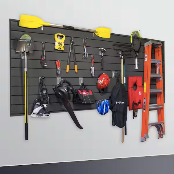 A hanging black wall organizer with tools and a multitude of items on them 