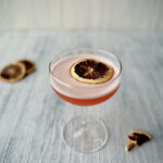 An aperol sour staged on a white background