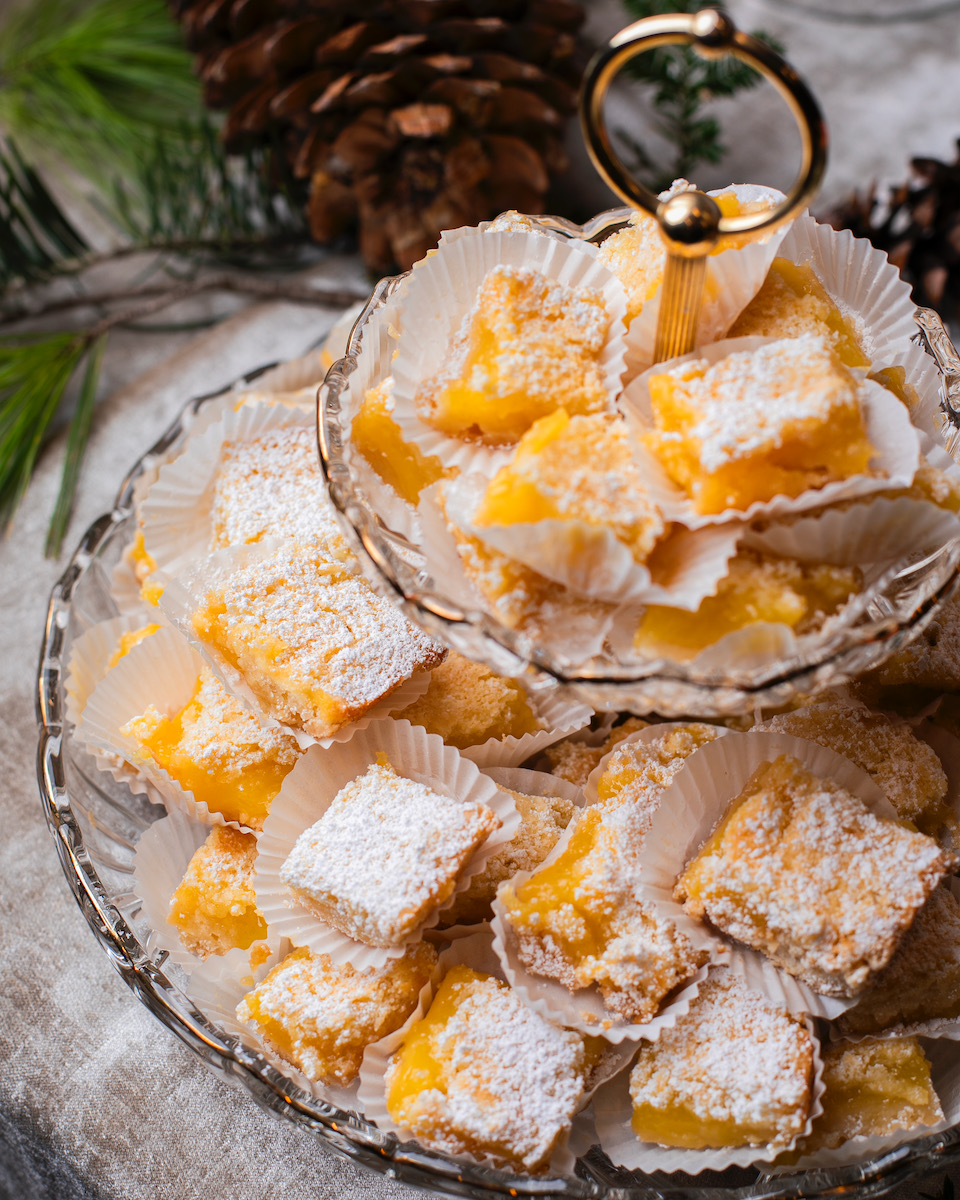 Lemon bars topped with confectionary sugar staged for a party