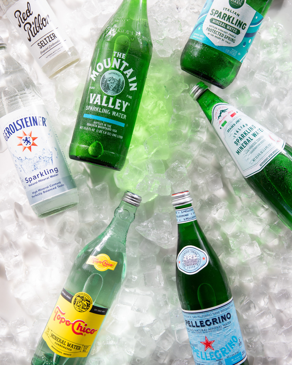 Four bottles of Italian sparkling mineral water on a bed of crushed ice.