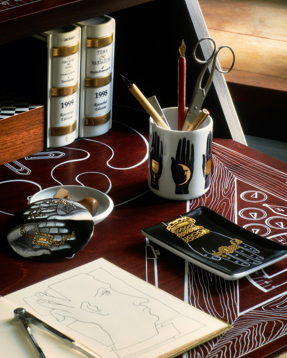 Porcelain objects on a red table top, staged with other design items 