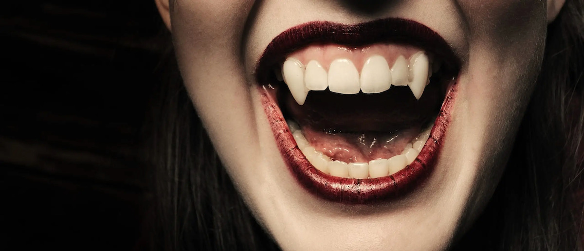 A set of vampire teeth on a black background