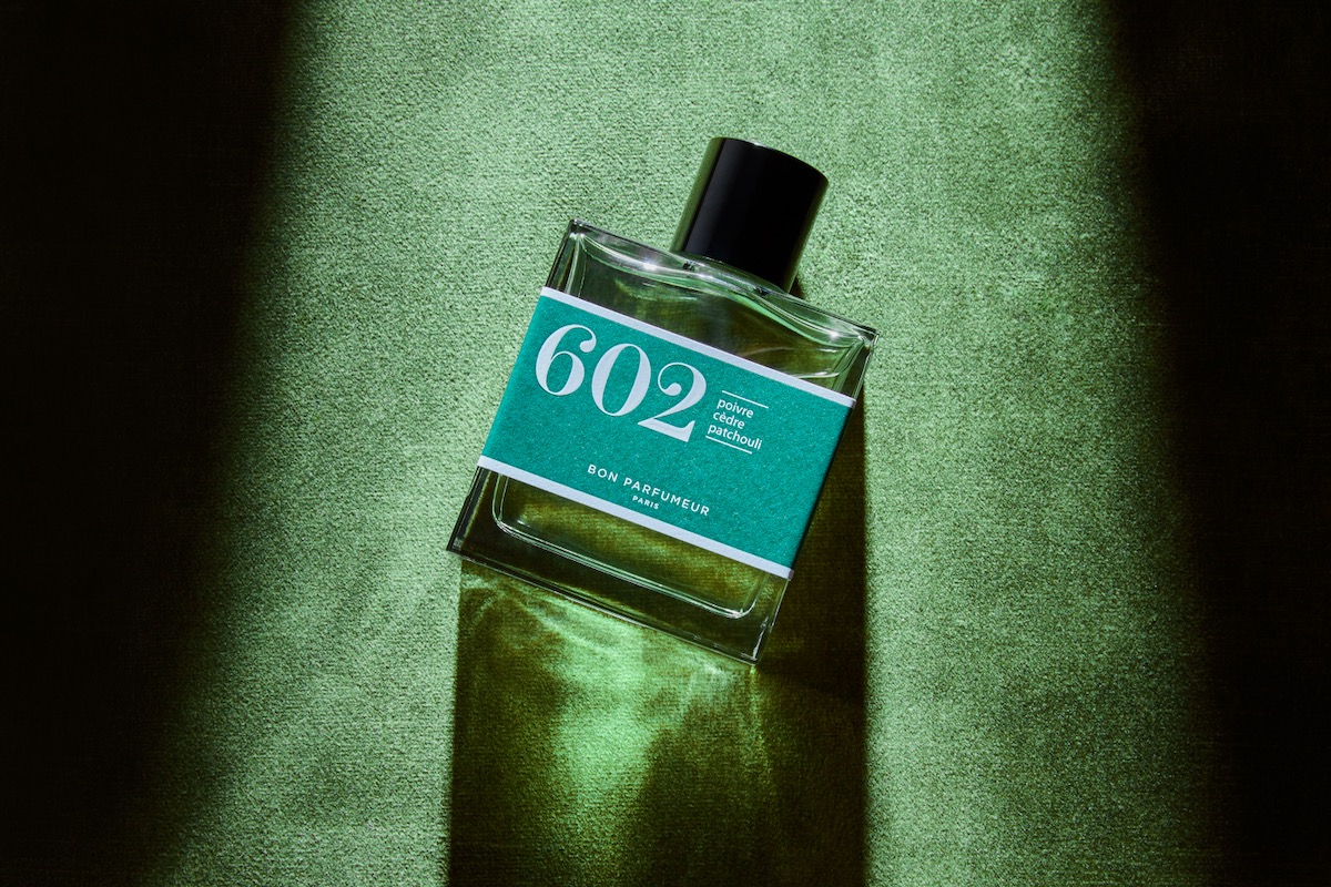 A bottle of perfume from Bon Parfumeur on a green backgroud