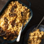 A delicious casserole dish of macaroni and cheese, made with a variety of cheeses and perfectly cooked elbow macaroni.