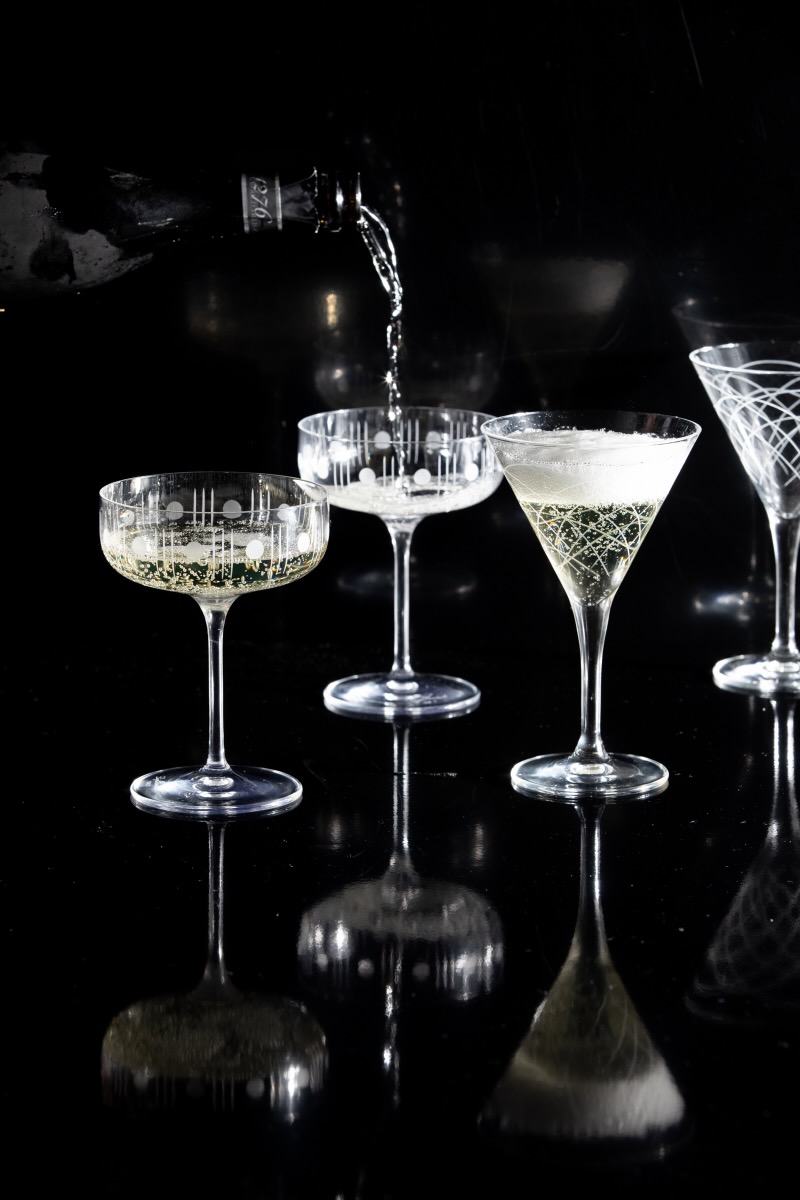 A set of champagne glasses on a black background