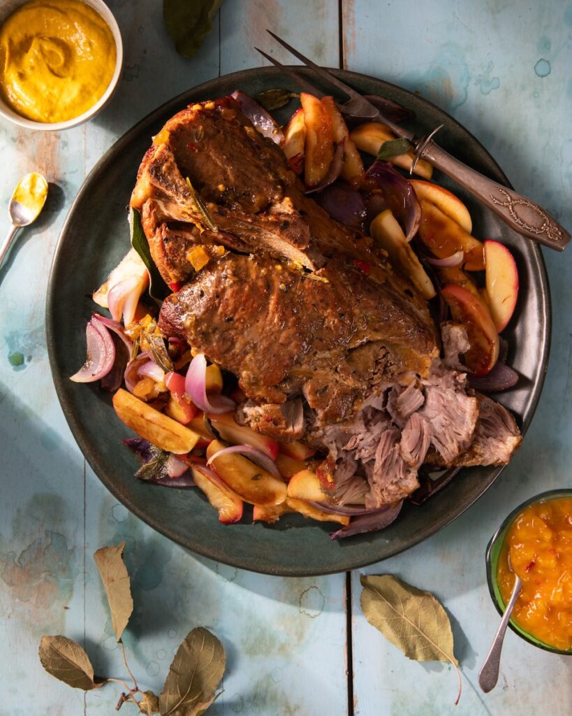 Apple mustard braised pork staged with bowls of Shenot's mustard.