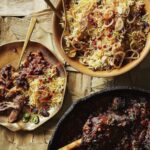 Persian Jeweled rice at a festive Nowruz table, served with chutney and lamb.